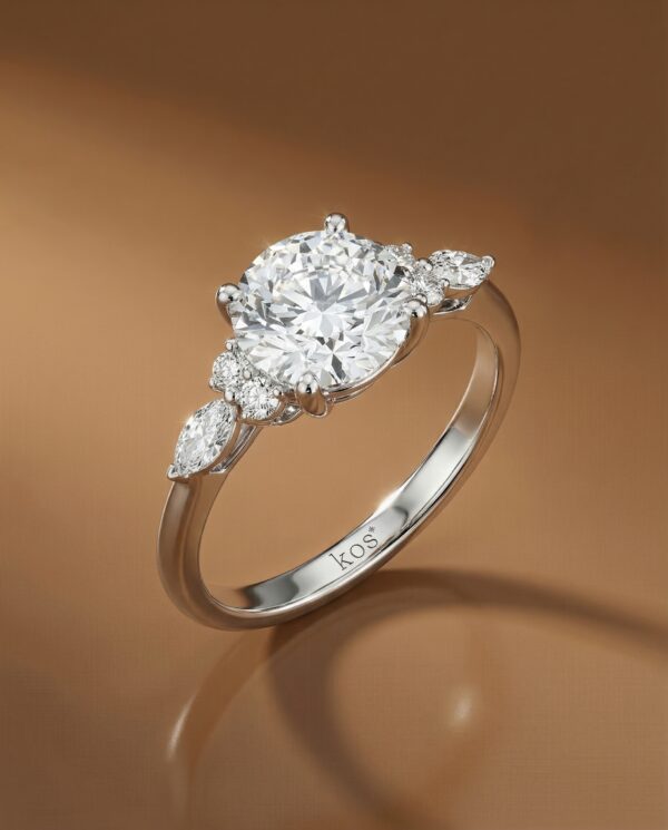 แหวนหมั้นเพชรกลมเม็ดกลาง ตัวเรือนทองคำขาว ประดับเพชรมาคีส์บ่าข้าง จาก Kos